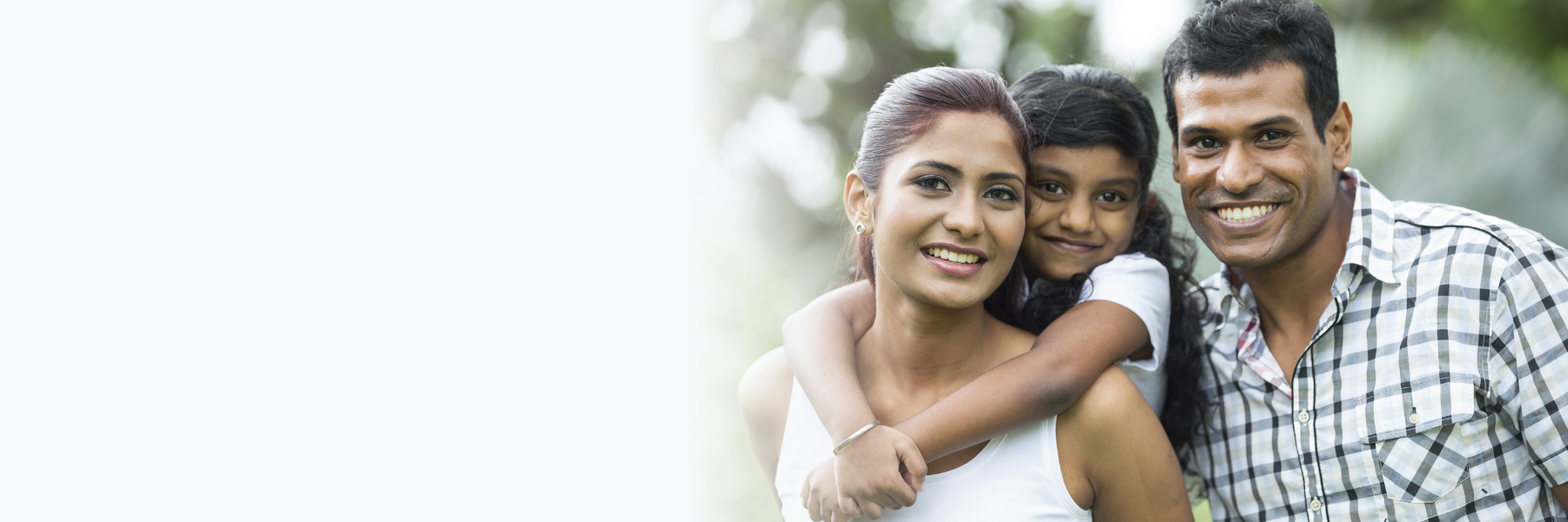 Smiling family with parents and young child outdoors, relating to custody