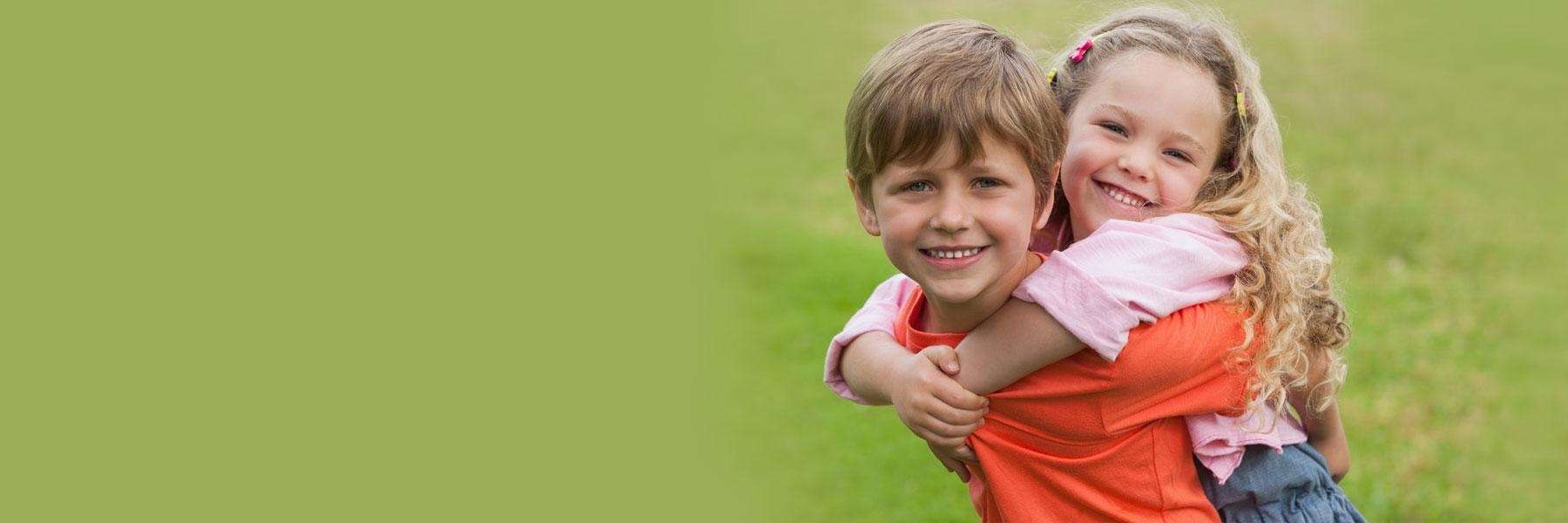 brother giving sister a piggy back ride