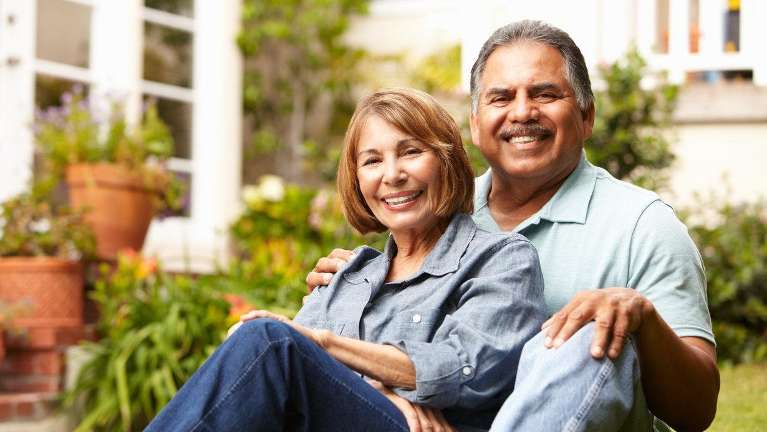 man and woman smiling after selling their house