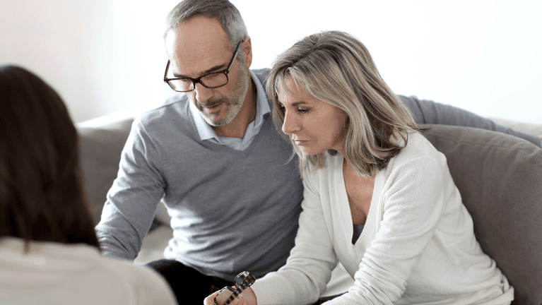 man and woman looking at divorce paperwork