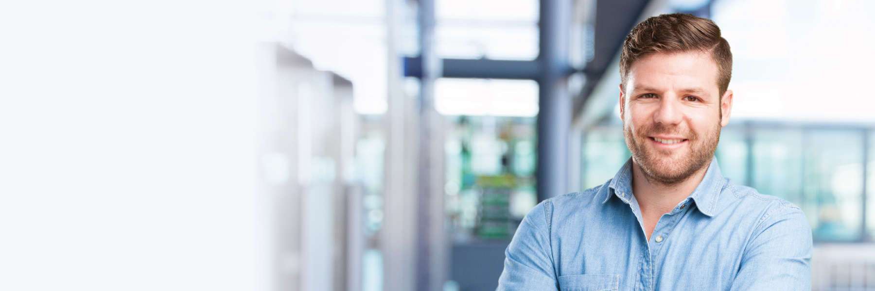 man smiling while standing in office
