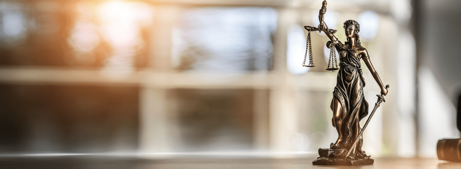 lady justice model sitting on a desk