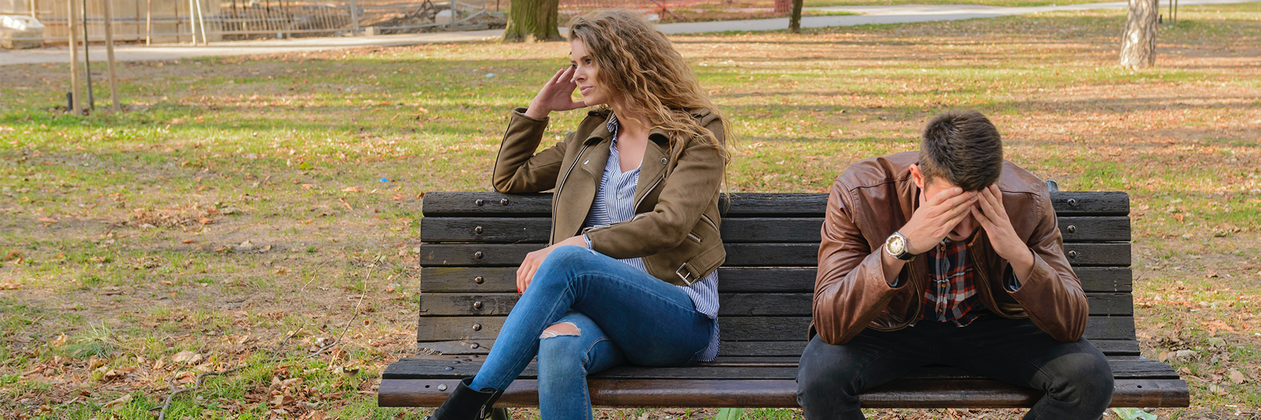 Man and woman sitting on bench during an argument 