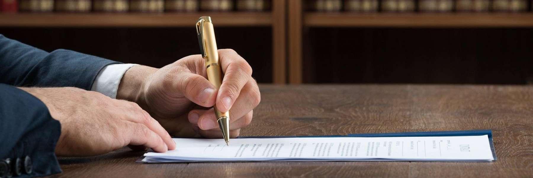close up of attorney signing legal paperwork in schaumburg