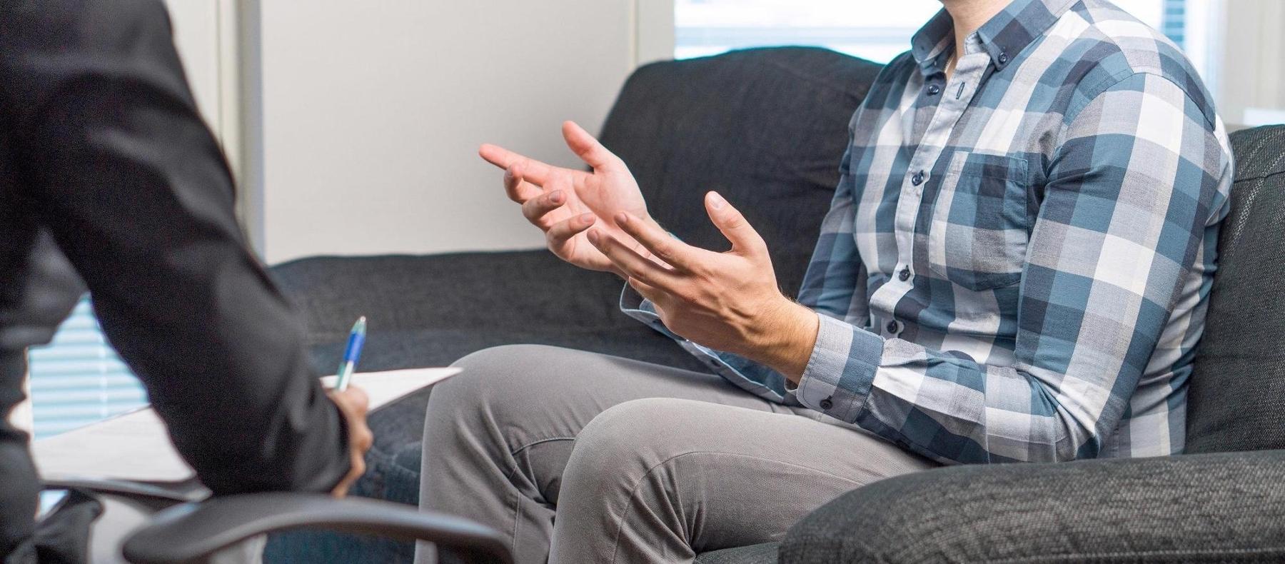 Man talking to lawyer during mediation in schaumburg